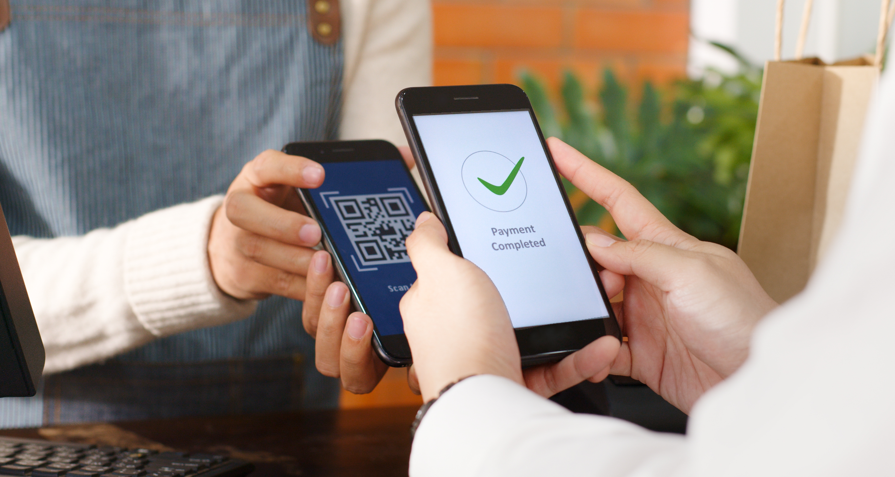 Person paying using a mobile on a mobile POS device Person paying using a mobile on a mobile POS device